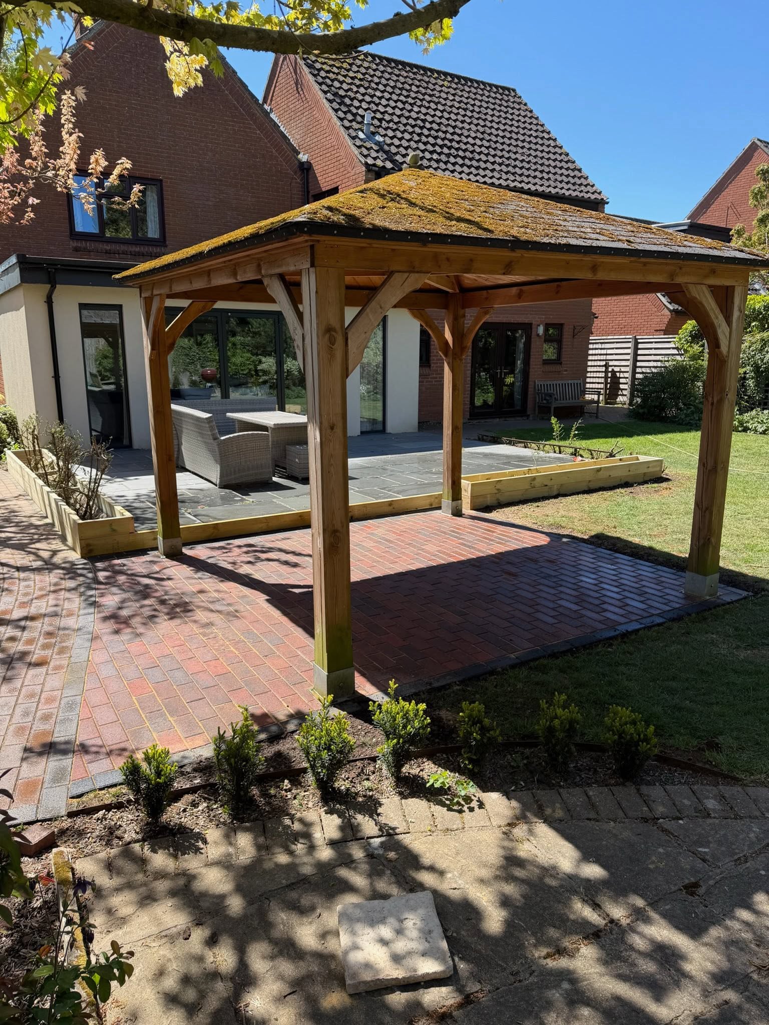 Expansive landscaped garden with stone patio